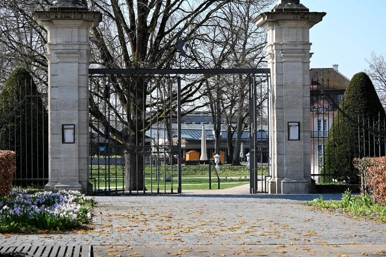 Automatic Driveway Gate Installation Louisville, KY, wrought iron automatic driveway gate at a stone entrance